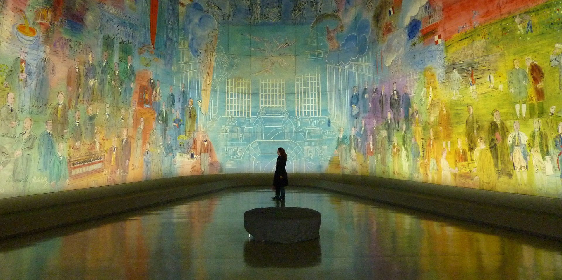 Woman watching a wall painting in a museum 